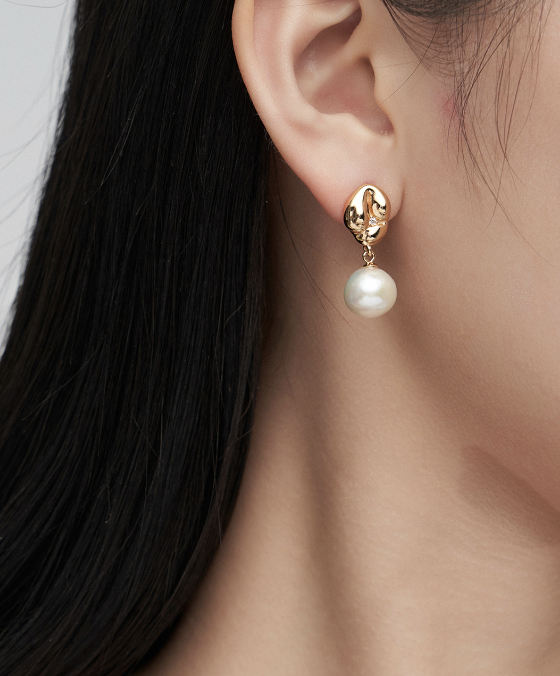 Sculpted Pearl Drop Silver Earrings worn by a model